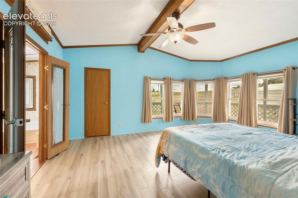 Image 18 of 38: Room featuring light wood-finish flooring, a bay window with multiple panes