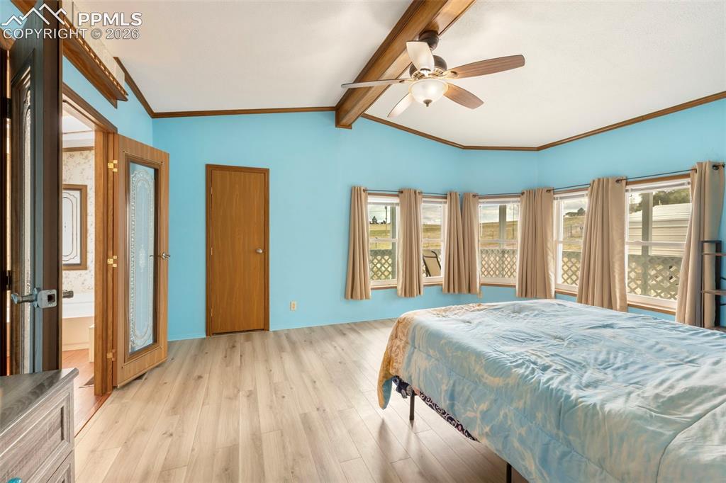 Image 26 of 38: Room featuring light wood-finish flooring, a bay window with multiple panes