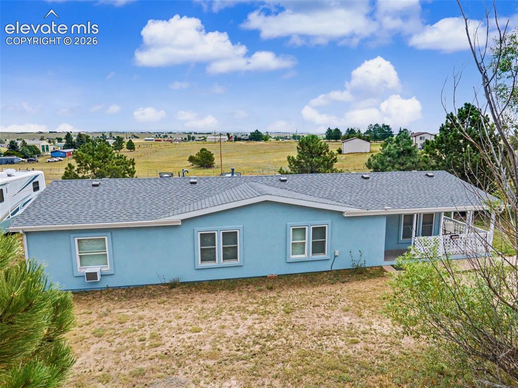 Image 26 of 38: Light blue siding exterior featuring multiple windows with white trim, a da