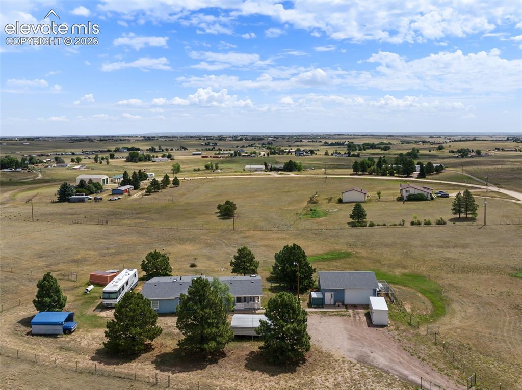Image 29 of 38: Rural property featuring a residence with an attached garage, a separate ou