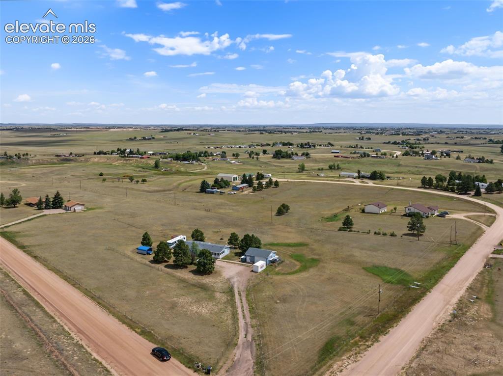 Image 38 of 38: Expansive rural property featuring an established home with a light-colored