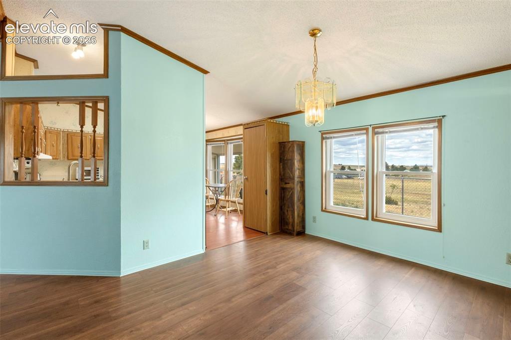 Image 9 of 38: Bright interior space featuring wood-finish flooring, light blue walls, and