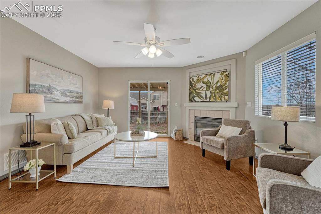 Image 15 of 47: Back inside to the main level living room with a gas fireplace and ceiling 