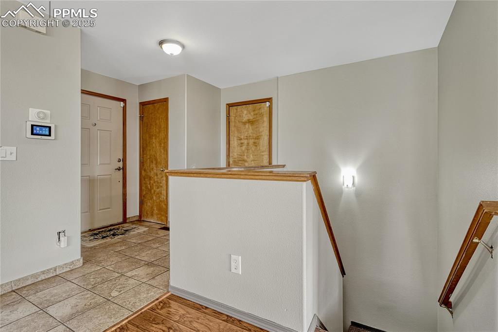 Image 25 of 47: View of entry, entry closet, door to garage, and stairs going down
