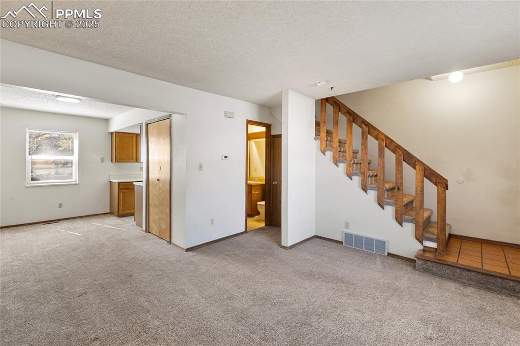 Image 10 of 32: Main level living room, dining room, kitchen and half bath 