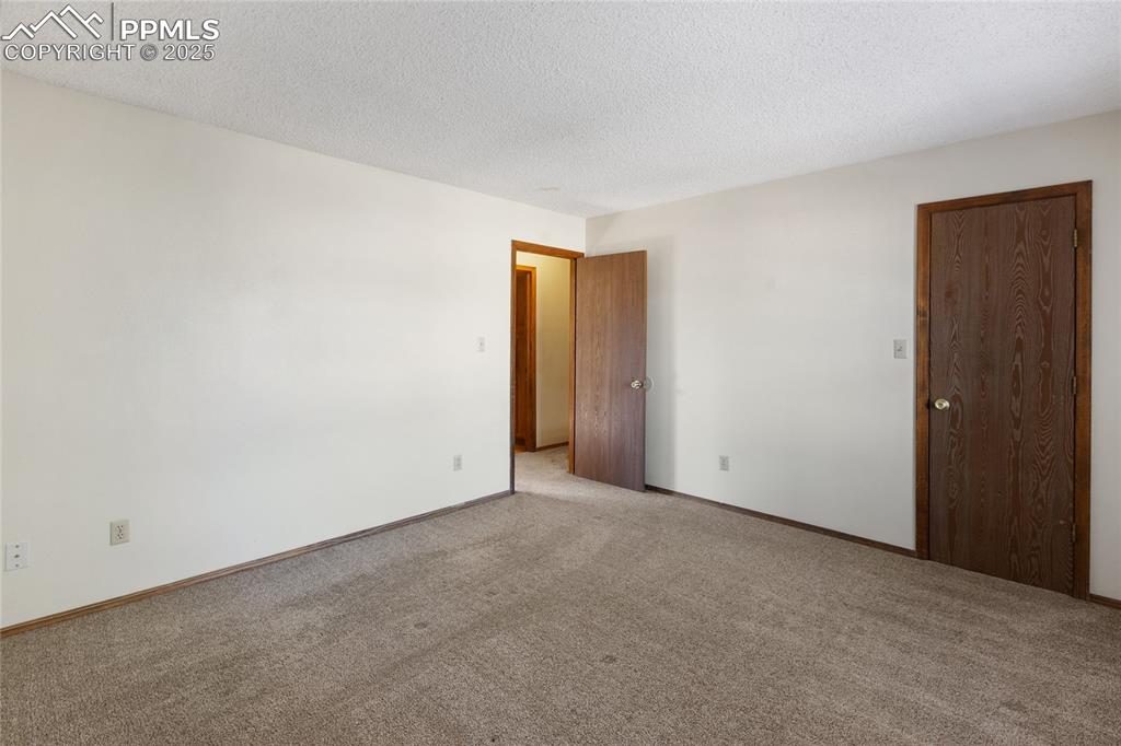 Image 22 of 32: Upper level bedroom #2 that faces the front of the condo