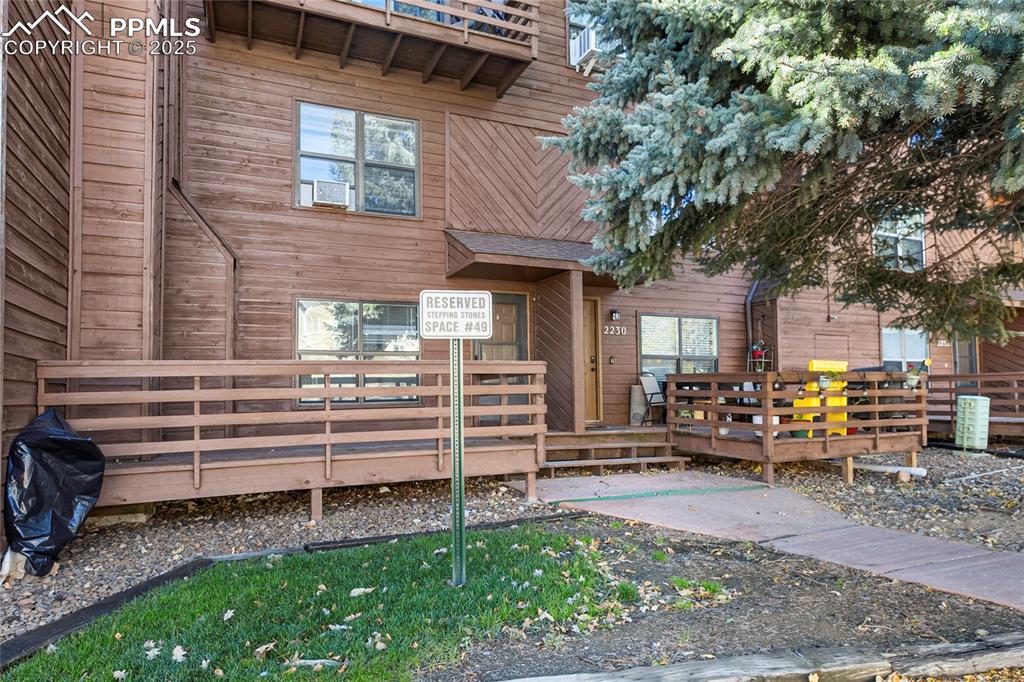 Image 3 of 32: Front entry with deck and parking