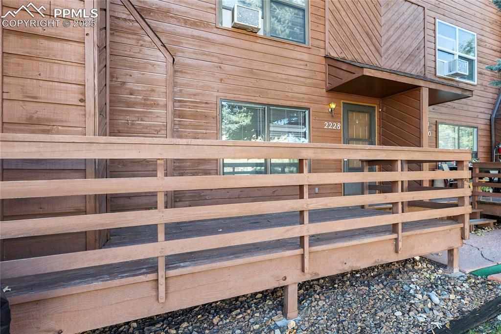 Image 4 of 32: Front door entry with deck