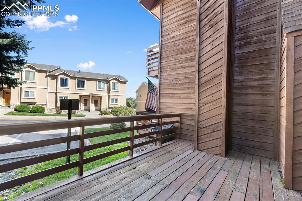 Image 7 of 32: Front deck facing parking area