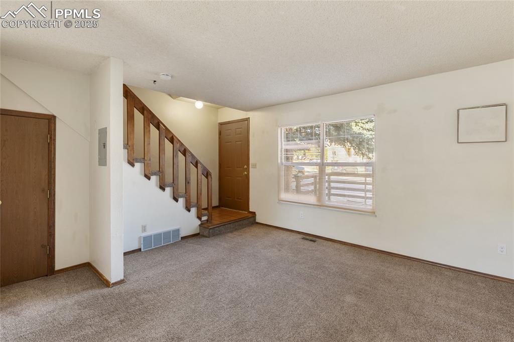 Image 9 of 32: Main level front entry and living room