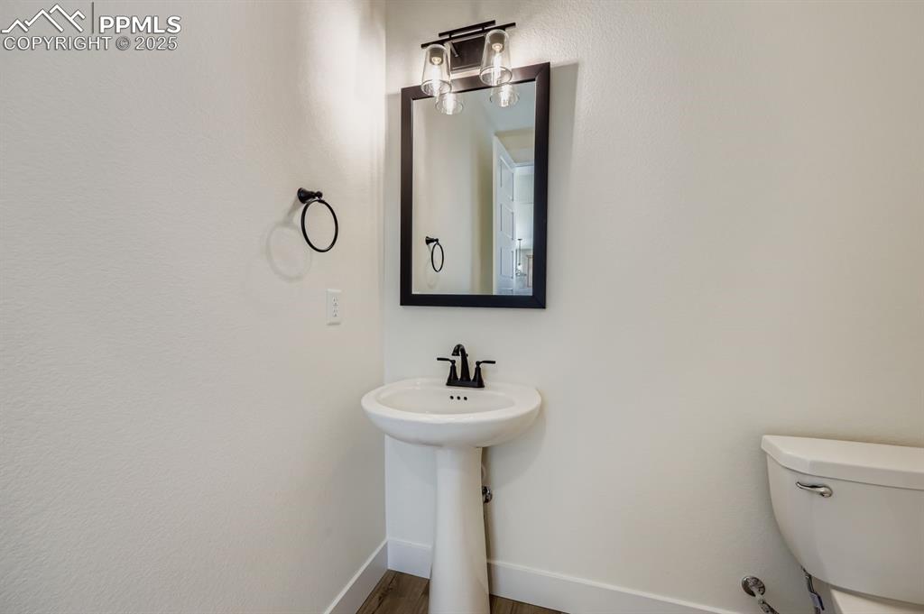 Image 11 of 28: Bathroom with baseboards and wood finished floors