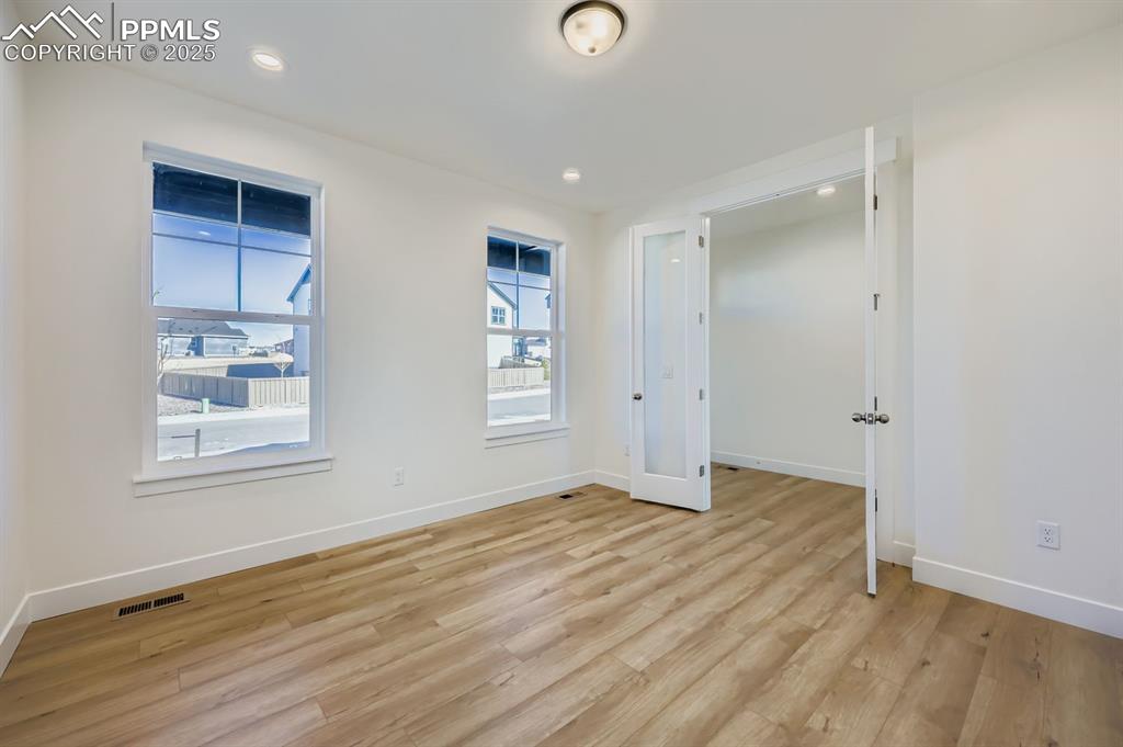 Image 6 of 28: Spare room featuring light wood-style floors and recessed lighting
