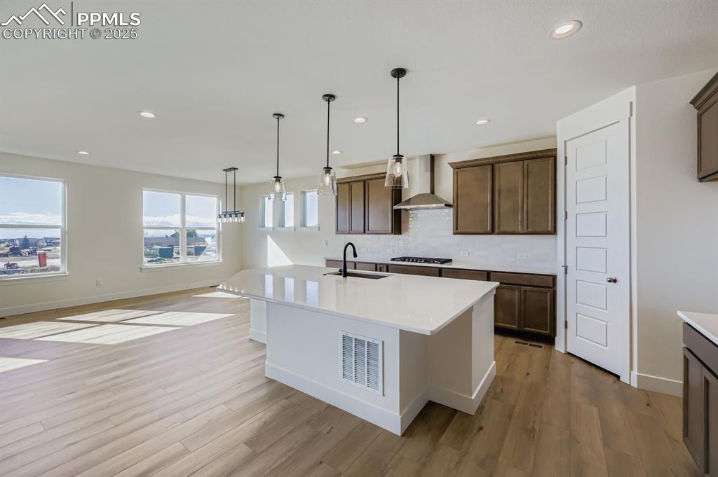 Image 7 of 28: Kitchen featuring decorative light fixtures, recessed lighting, tasteful ba