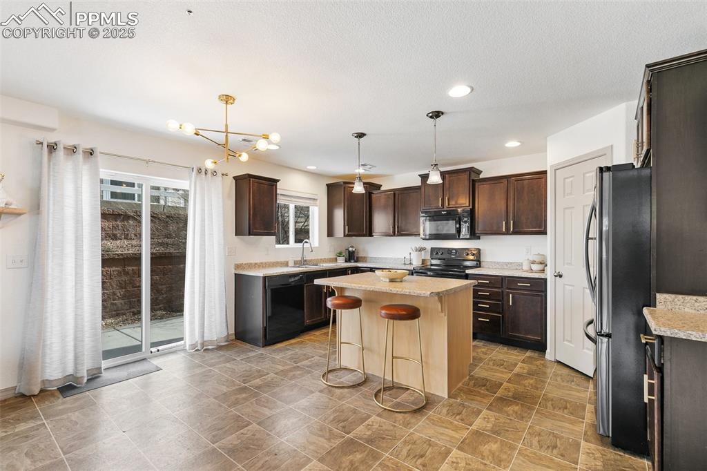 Image 6 of 17: Kitchen Opening Up To The Back
Patio