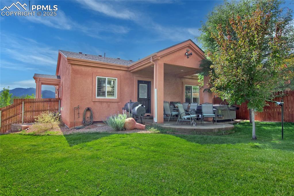 Image 33 of 36: The backyard is fully landscaped with gorgeous grass and 

trees and it is 