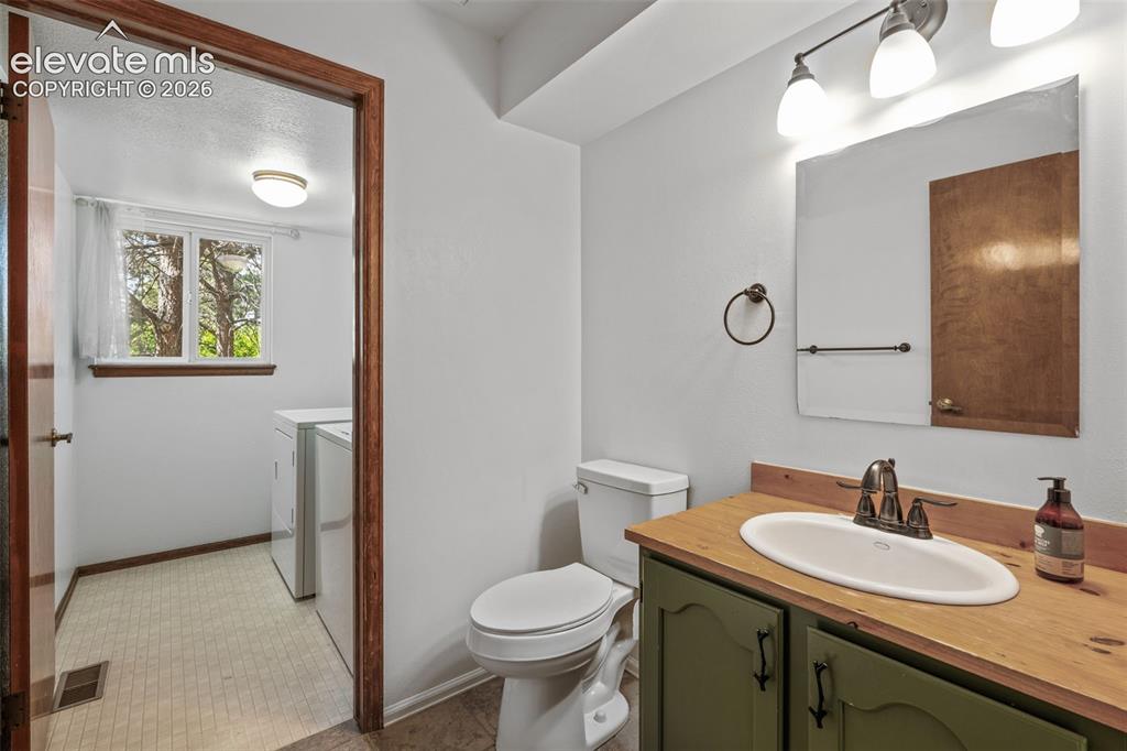 Image 20 of 50: Bathroom Powder room and laundry