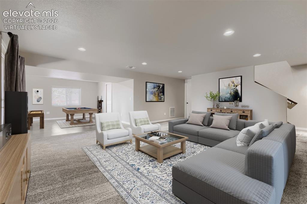 Image 32 of 50: Virtually staged basement family room with walkout, large rec room that can