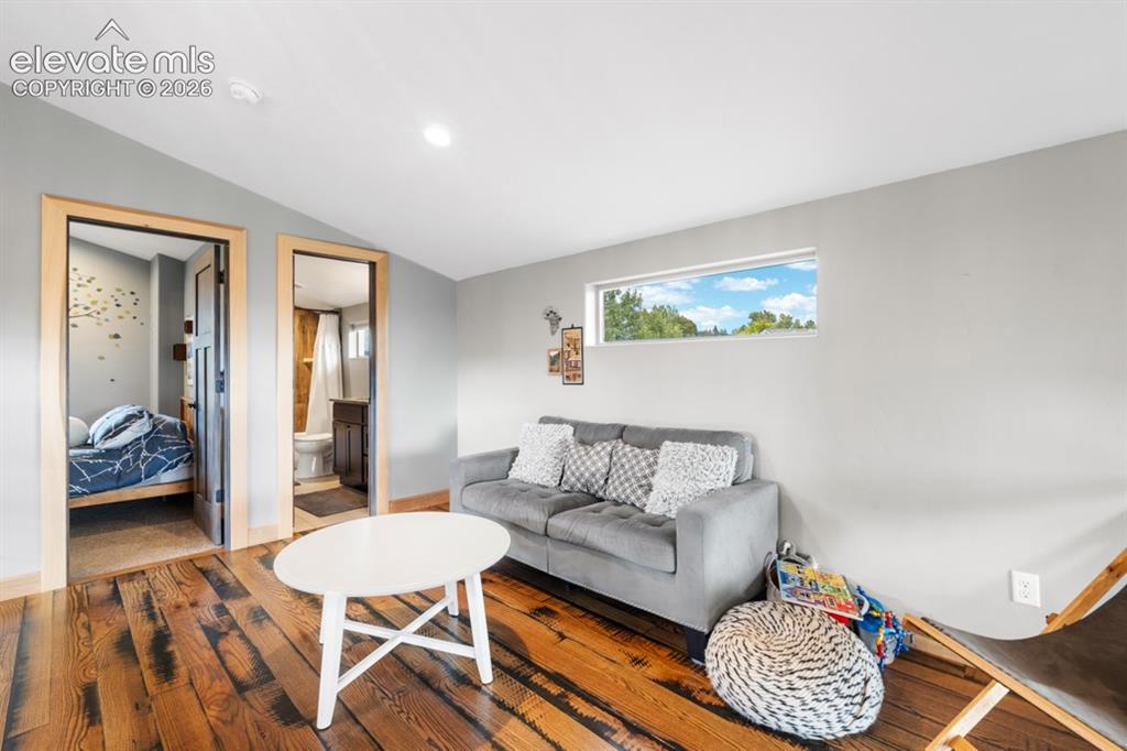 Image 18 of 50: Hardwood flooring, recessed ceiling lighting, light gray wall finishes, hor
