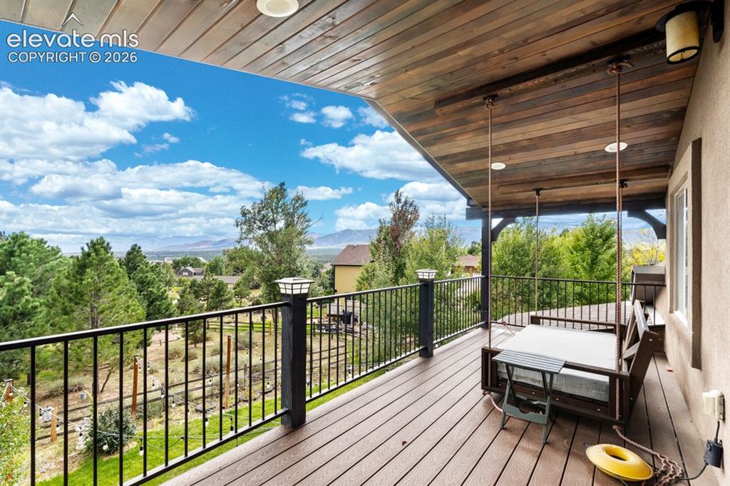 Image 22 of 50: Expansive covered deck featuring wood-finish flooring, a wood-plank ceiling