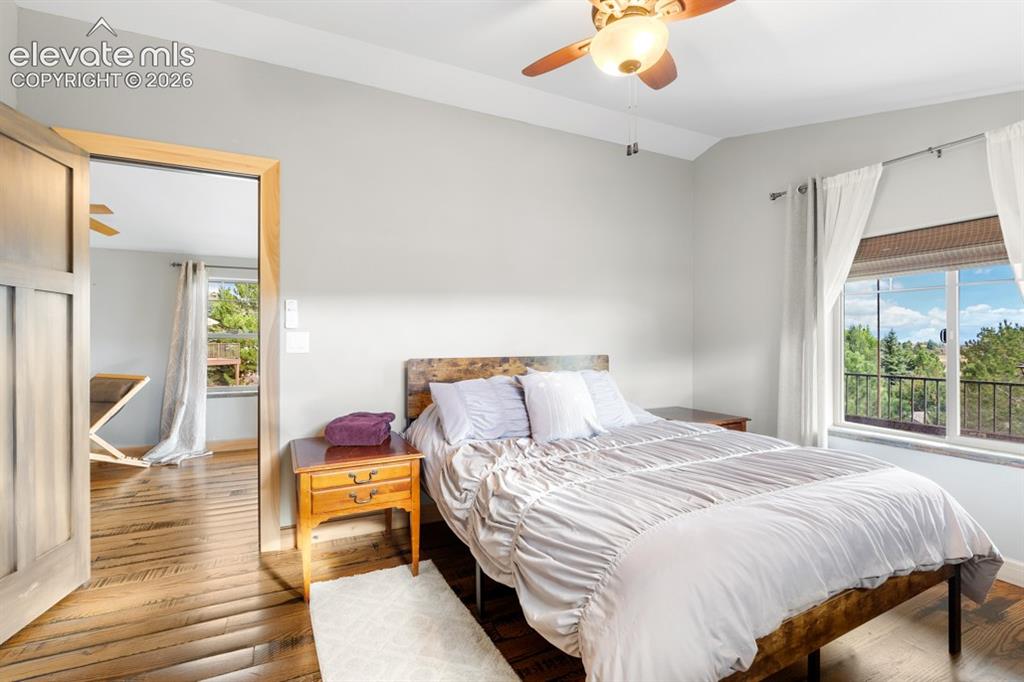 Image 24 of 50: Light wood-finish flooring, a ceiling fan with integrated lighting, and a l