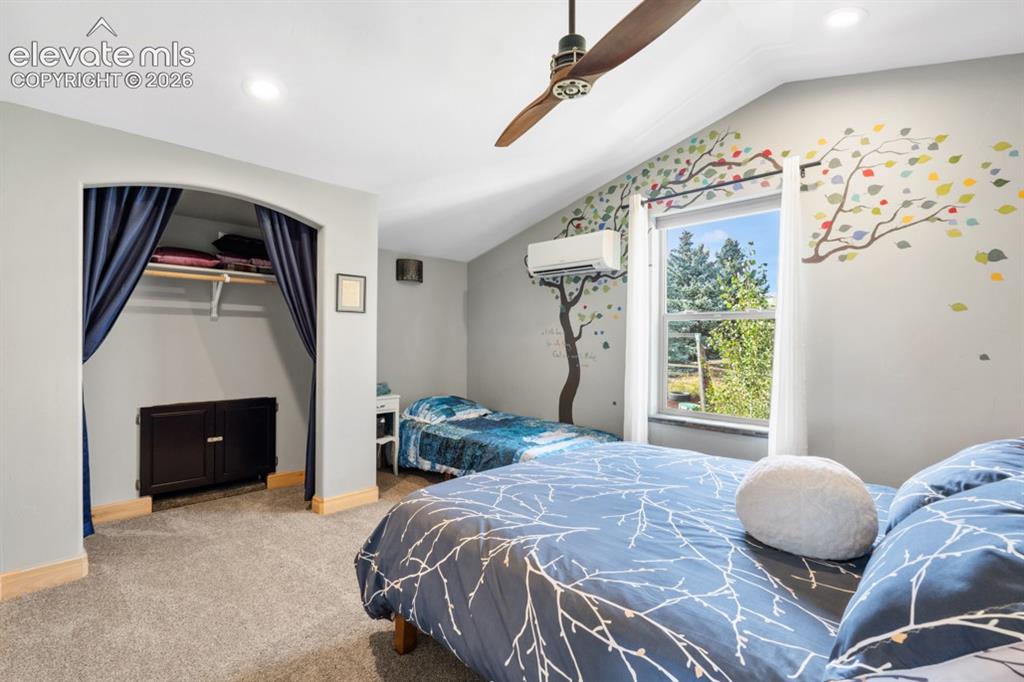 Image 26 of 50: Vaulted ceiling with an integrated ceiling fan, recessed lighting, carpet f