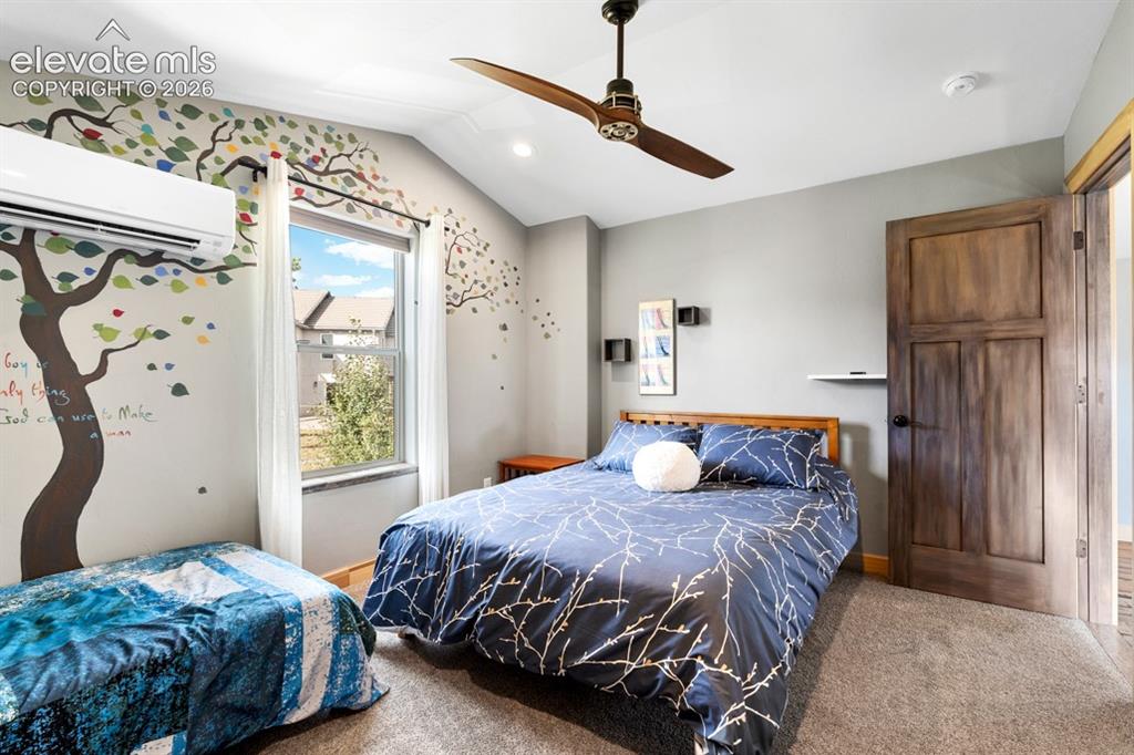 Image 27 of 50: Vaulted ceiling, ceiling fan, wood-finish door, window with natural light, 