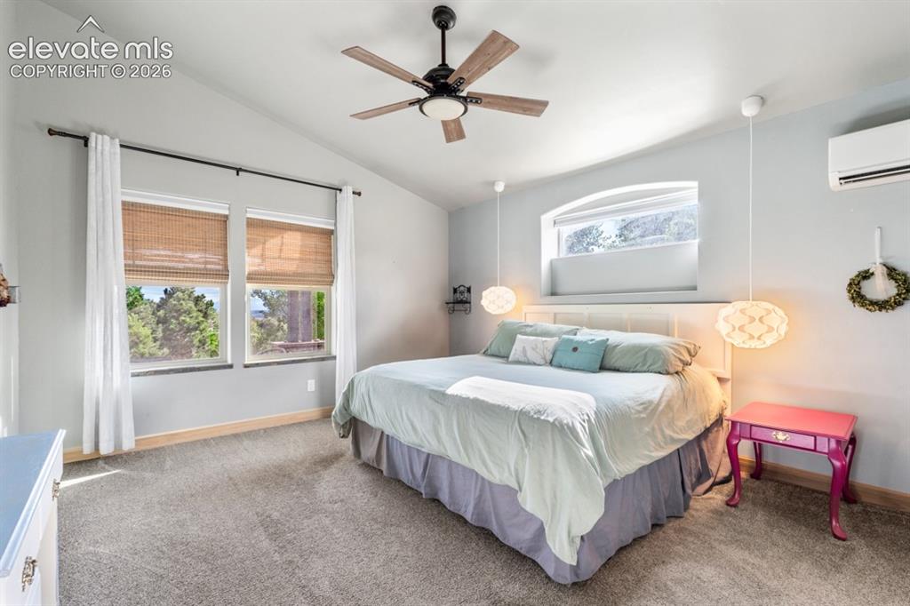 Image 29 of 50: Vaulted ceiling with a ceiling fan, dual windows, arched transom window, an