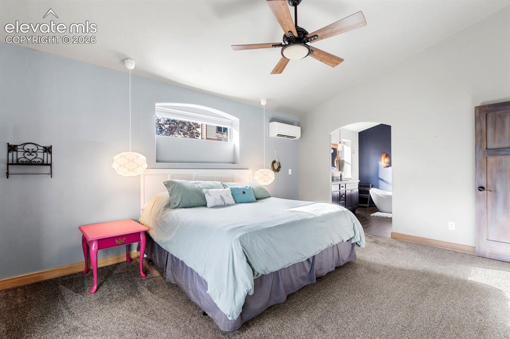 Image 30 of 50: Vaulted ceiling with a wood-finish ceiling fan, recessed window alcove, and