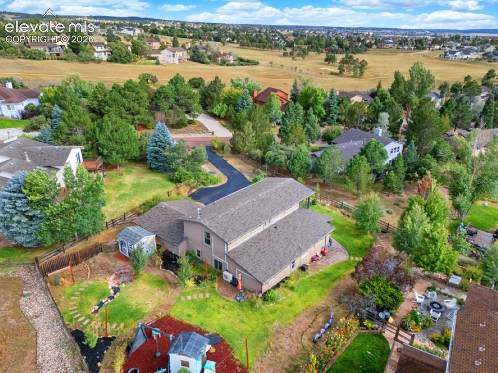 Image 5 of 50: Expansive property featuring a multi-level structure with a covered patio, 
