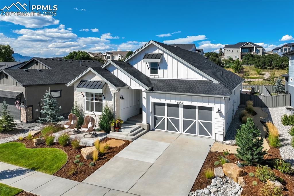 Caption: Modern farmhouse architecture w/board-and-batten siding + stone accents | Design-forward interior—re