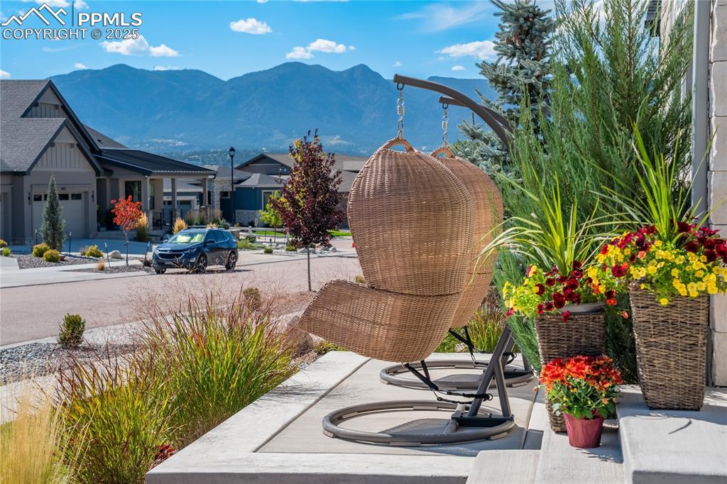 Image 2 of 50: Extended front porch w/Air Force Academy + mountain views
