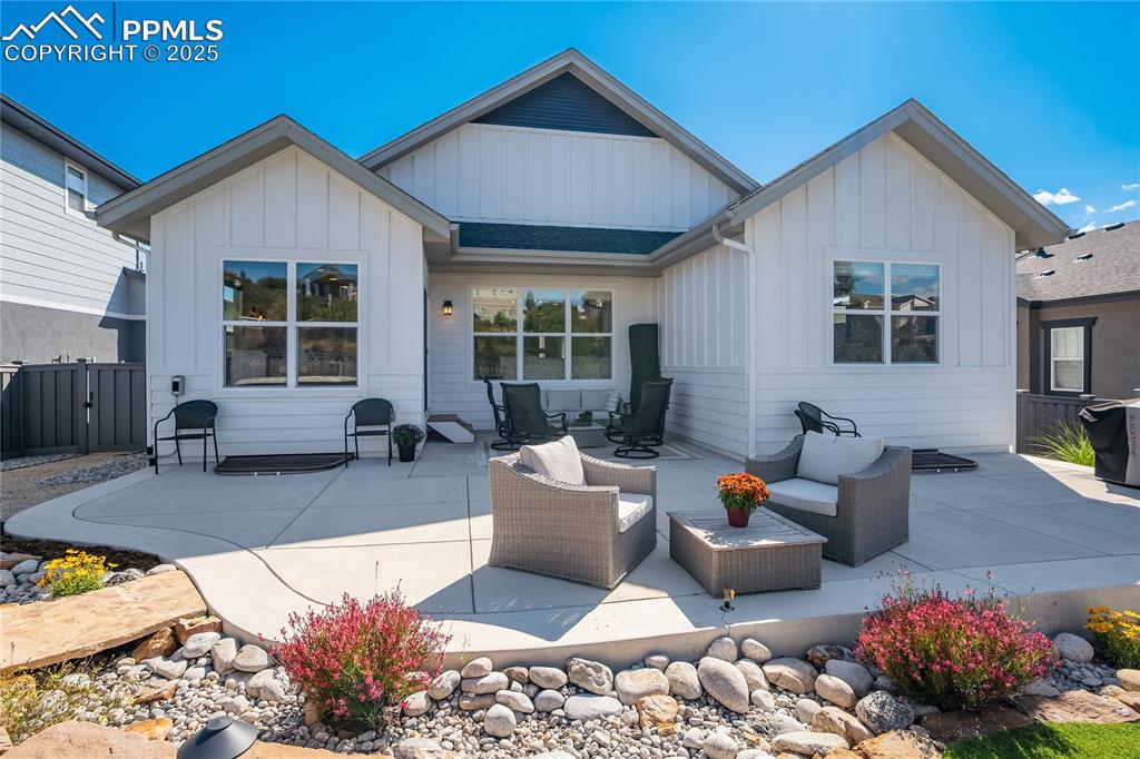 Image 38 of 50: Extended concrete rear patio with mountain views — perfect for outdoor ente