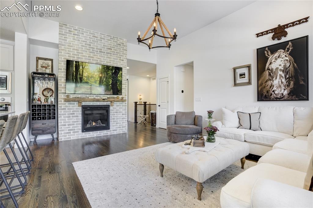 Image 7 of 50: Great room with walls of windows, gleaming hardwood floors, and a floor-to-