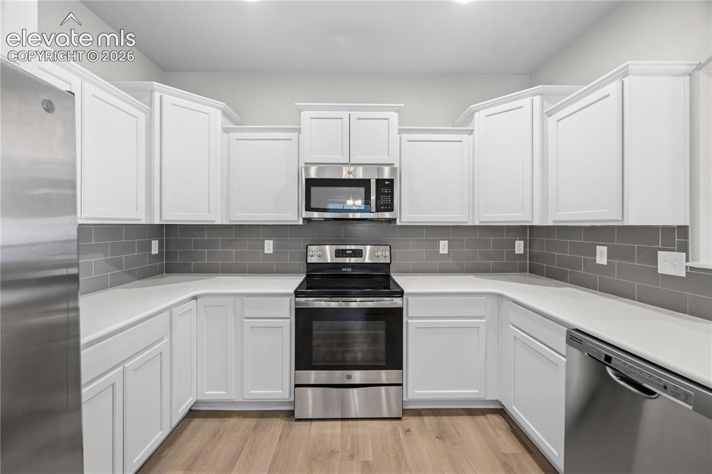 Image 11 of 44: beautiful stainless steel appliances and quartz countertops