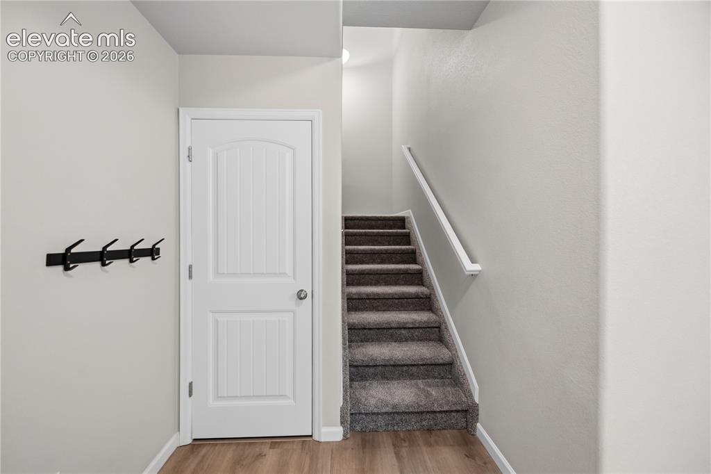 Image 37 of 44: storage closet to the left of the stairs