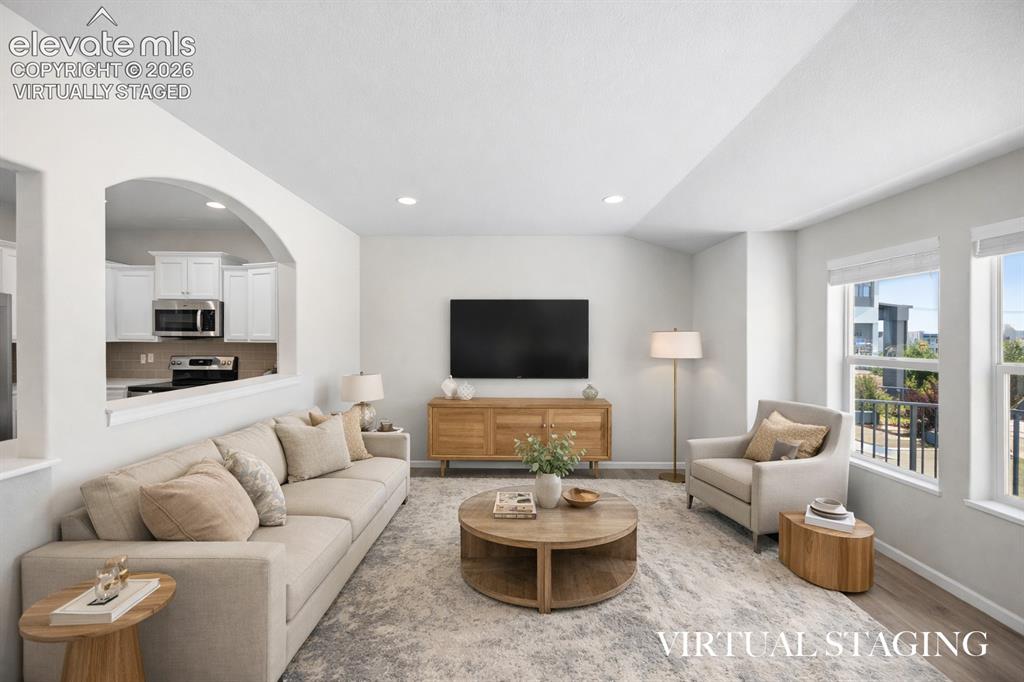 Image 5 of 44: Virtually staged. Opens up nicely to the kitchen and offers lots of natural