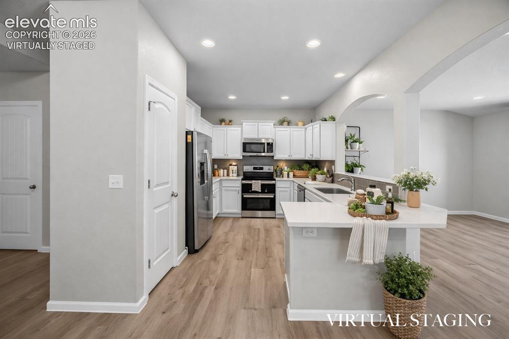Image 9 of 44: Virtually Staged spacious kitchen opens up nicely to the living room and di