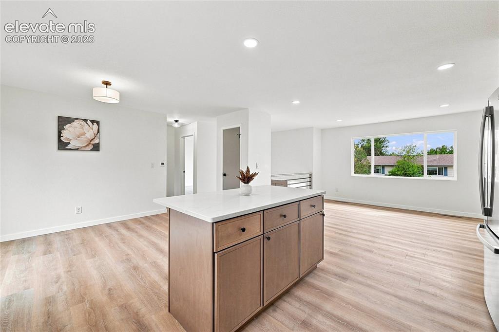 Image 9 of 30: Open concept living space featuring wood-finish flooring and recessed light