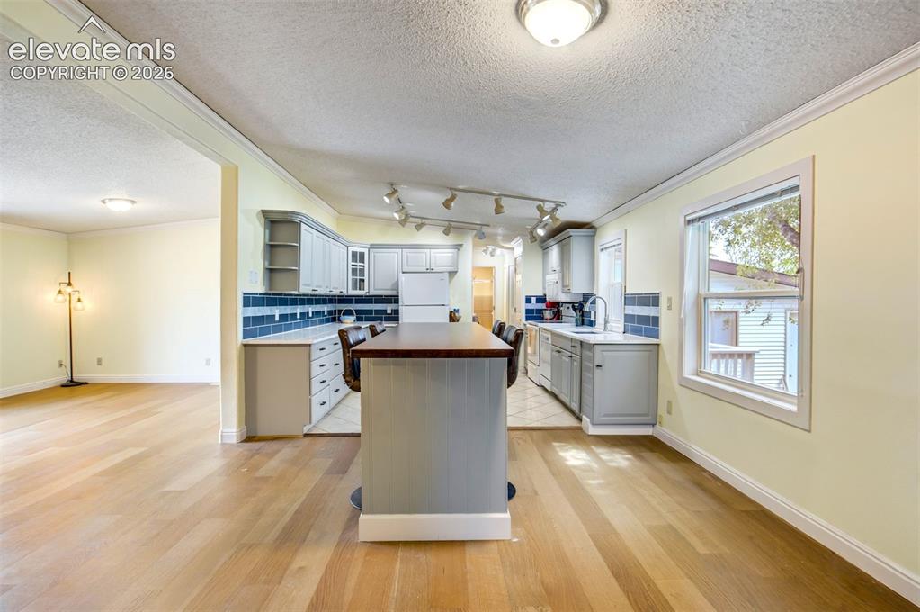 Image 16 of 50: Open layout with oversized island and seating area.