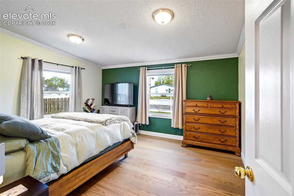 Image 20 of 50: Updated flooring continues into the bedroom spaces.