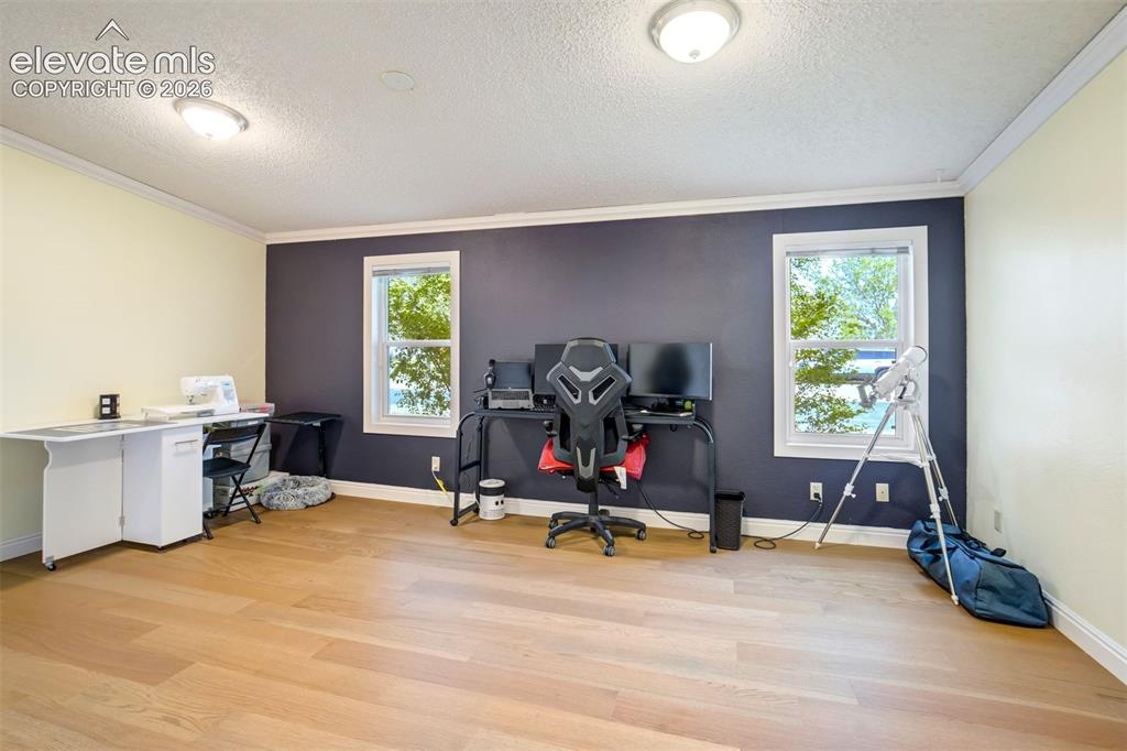 Image 29 of 50: Expansive primary bedroom offers flexibility for additional seating or work