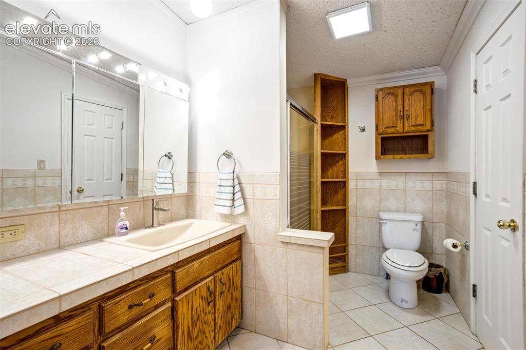 Image 31 of 50: Large primary bath includes an oversized vanity, built-in cabinetry, and wa