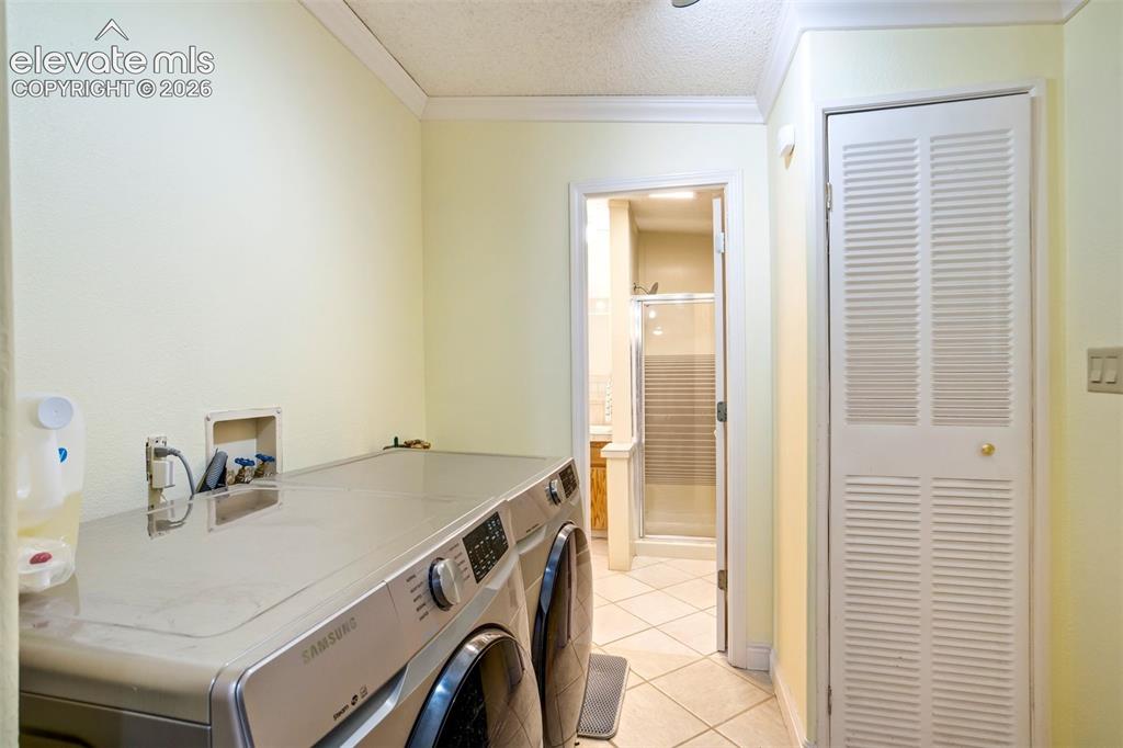 Image 36 of 50: Convenient laundry area located near the primary suite for added functional