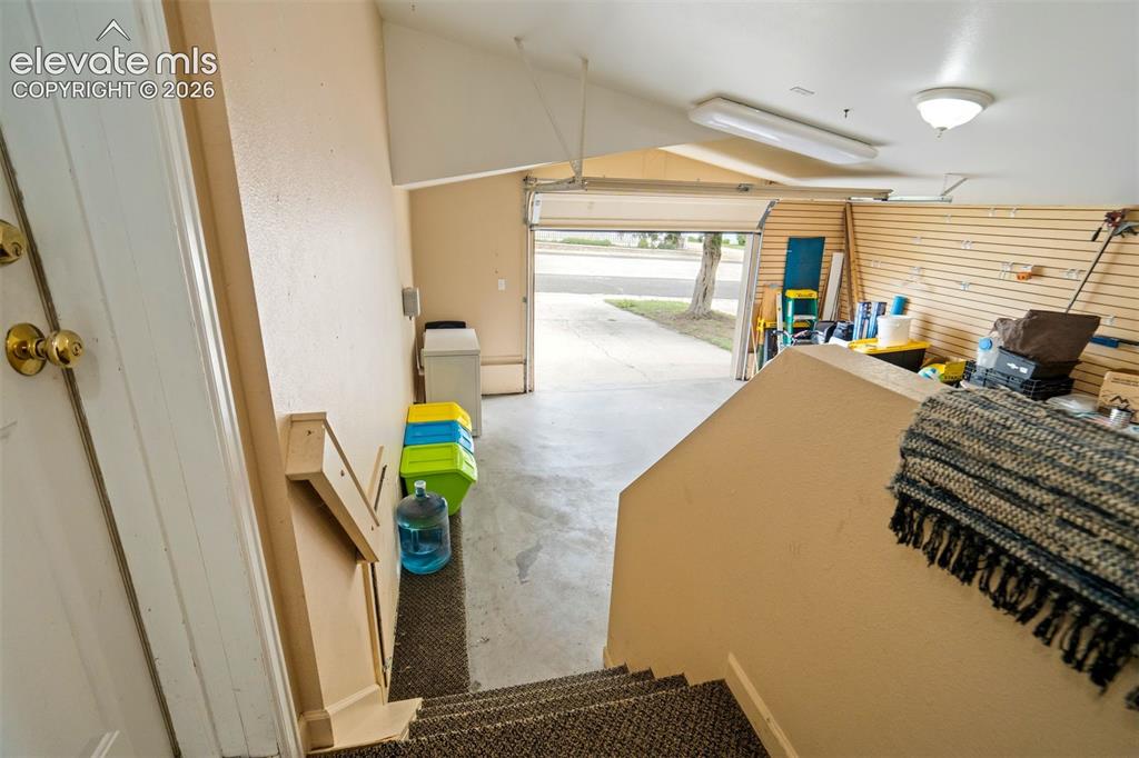 Image 37 of 50: Attached oversized garage offers excellent space for parking, storage, hobb