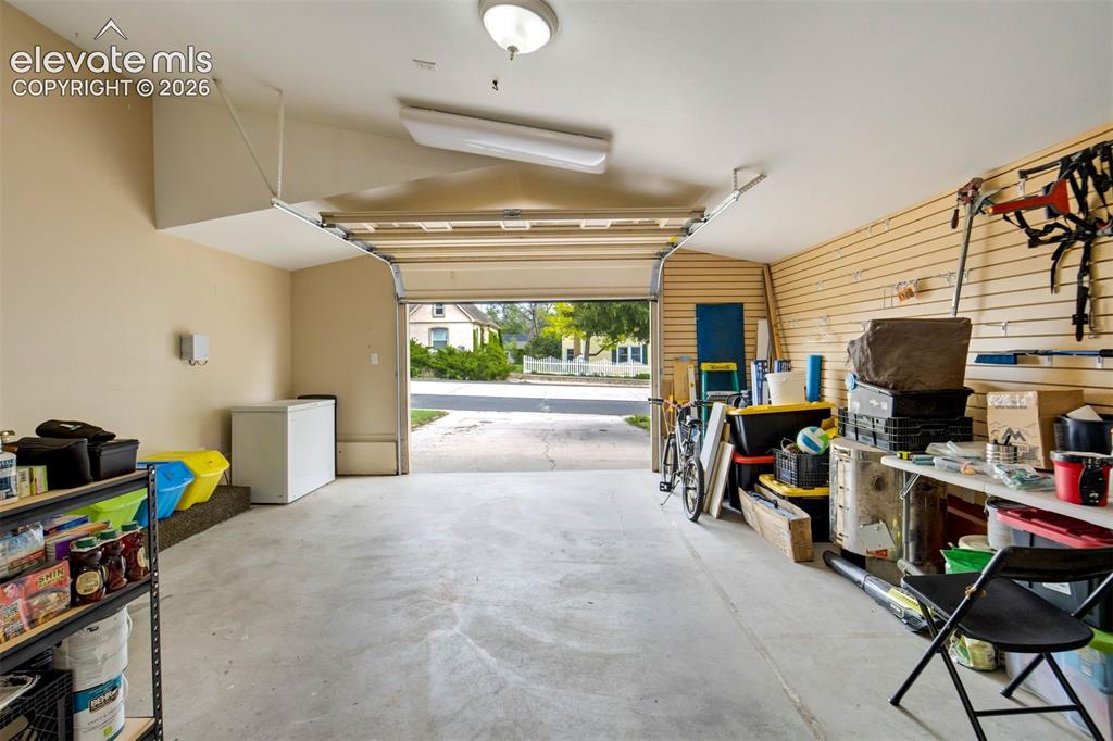 Image 39 of 50: Large garage space provides versatility for parking, storage, home gym, or