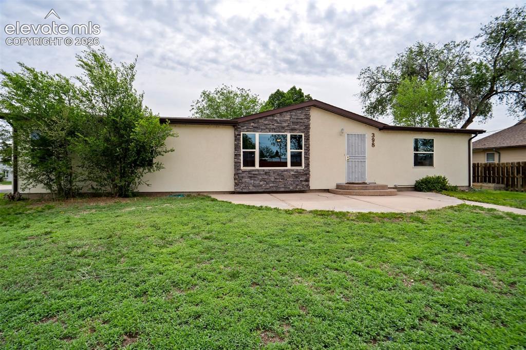 Image 4 of 50: Decorative stonework creates a warm and inviting front exterior.