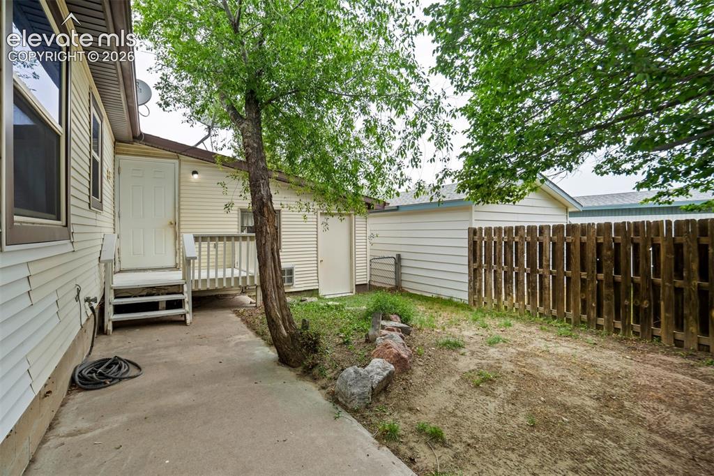 Image 40 of 50: Rear patio and deck area.