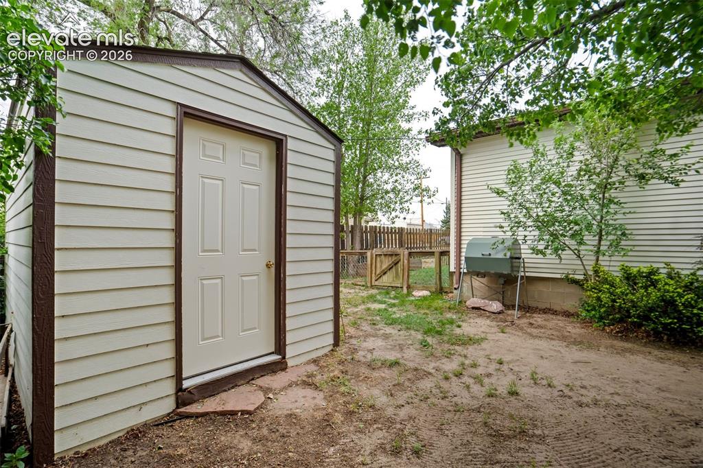 Image 43 of 50: Storage shed provides additional space for tools and outdoor equipment.