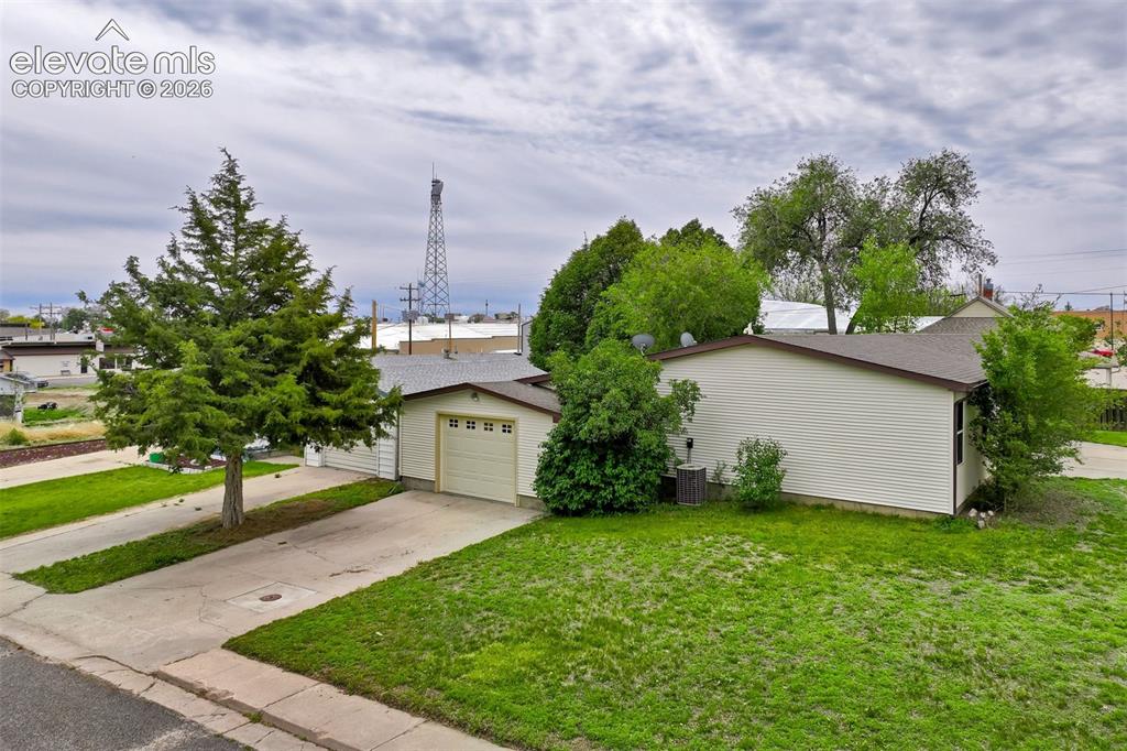 Image 47 of 50: Corner lot setting provides additional yard space and an open exterior feel