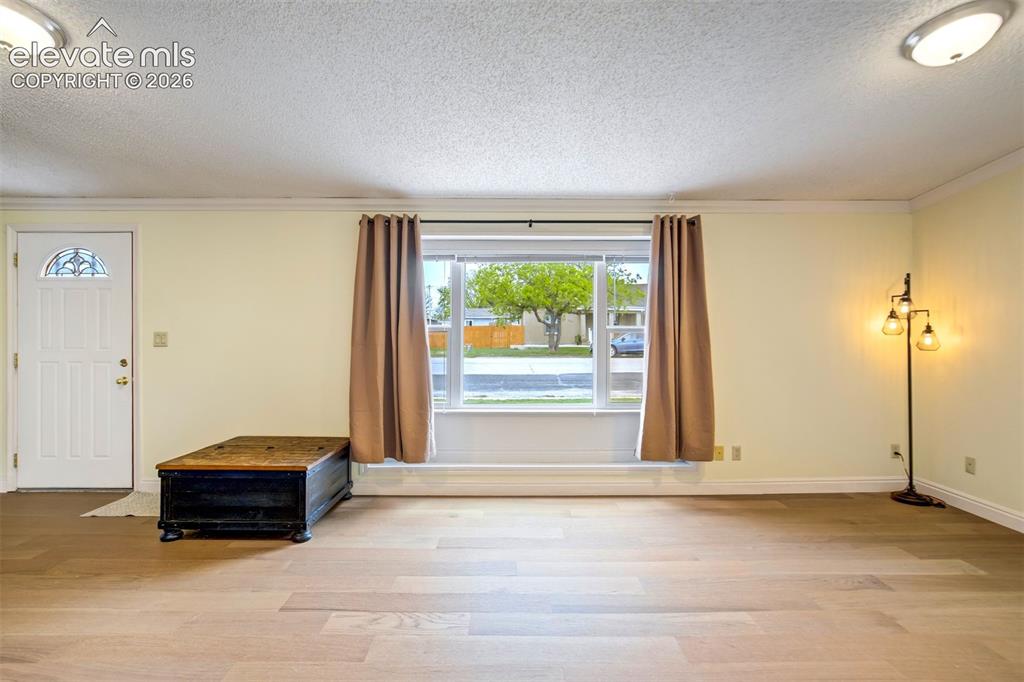Image 8 of 50: Front living room with natural light, neutral tones, and an open layout.